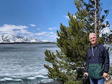 Pat in front of tree and lake at Grand Teton National Park