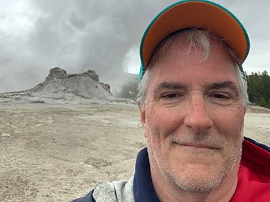 Pat in front of Yellowstone National Park geyser