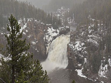 Yellowstone National Park snow falling on waterfall