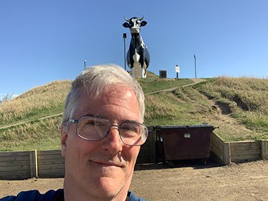 Pat with World's Largest Holstein Cow on hill