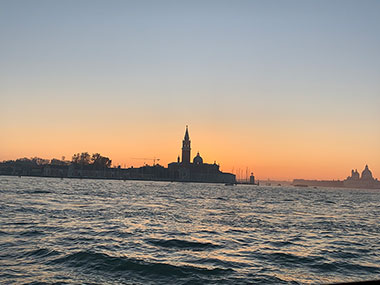 Waves on the water with island in distance