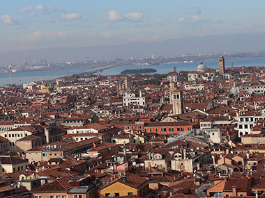 Venice stretches along water and mountains as viewed from St. Mark's Bell Tower