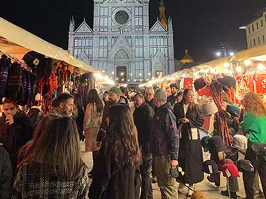 People standing in front of booths at Christmas Market