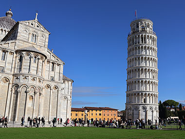 Grass with the Pisa Cathedral to the left of Leaning Tower of Pisa