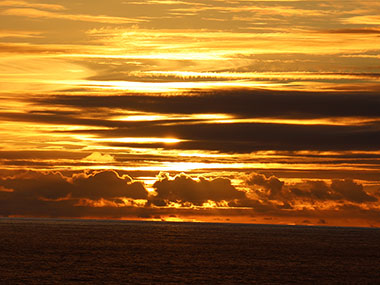 Sunset beyond clouds