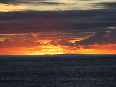 Reddish sky in the distance as sun sets