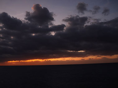 Red light beyond dark clouds