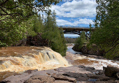 waterfall with lake in distance