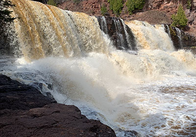 Red ledge in front of waterfall