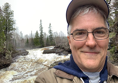 Pat in front of the river