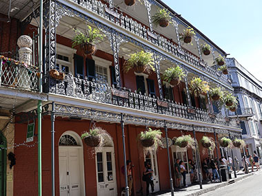 Baskets of ferns adorn balcony