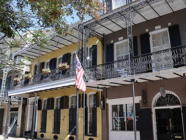 American flag hangs from balcony of building