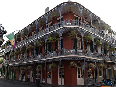 Red three story building with balconies