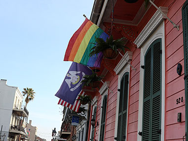 Several flags fly over building