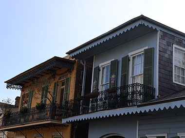 Two buildings with black window shutters