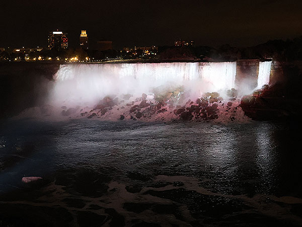 White light shines on Niagara Falls as viewed from Canadian side