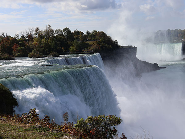 Closeup of Niagara Falls from American side with more waterfalls in background