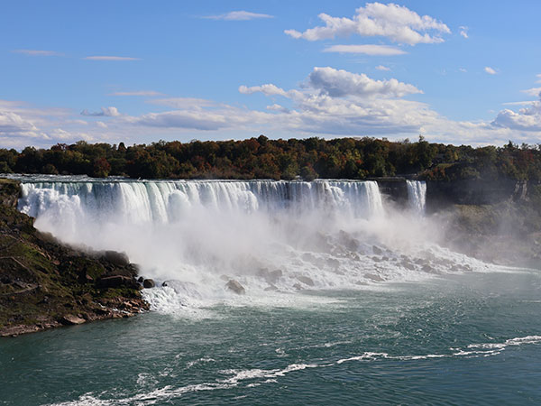 White puffy clouds over Niagara Falls as viewed from Canadian side
