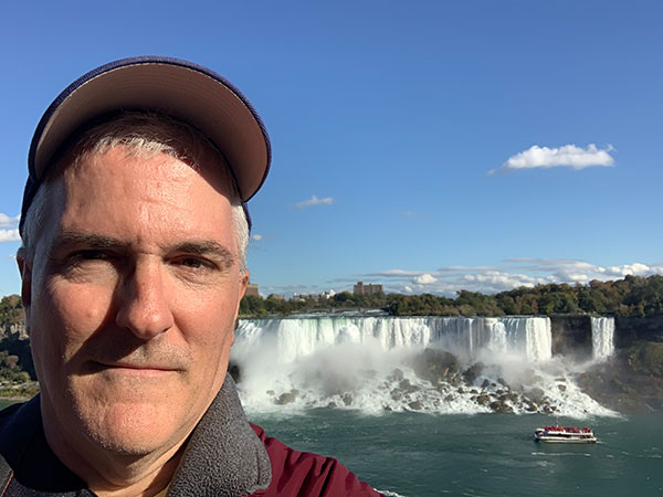 Pat stands in front of Niagara Falls on Canadian side