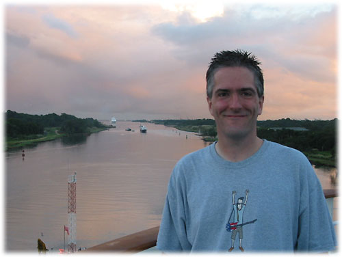 Pat with entrance to Panama Canal behind him