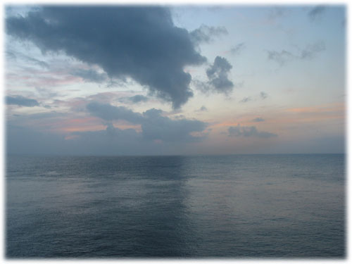 Clouds reflect on water during sunset