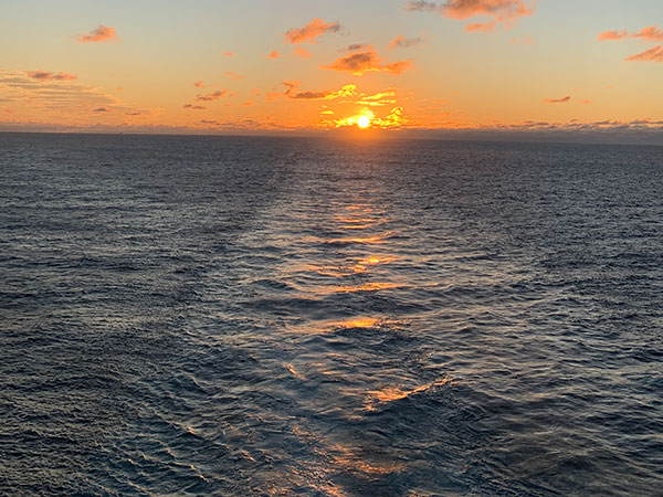 Sun behind cloud at sunset