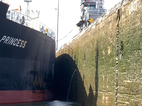Ship next to wall of Panama Canal