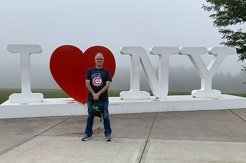 Pat in front of I heart NY sign
