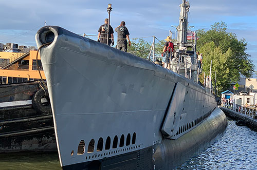 USS Cod pushed into port
